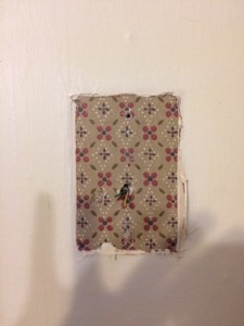 A hint of kitchen past once hidden behind a phone jack. We joked about removing all the paint and restoring the wallpaper to its old glory:)